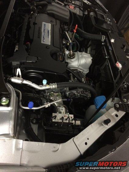 Engine bay of a 2014 Honda Accord, showing the Earth Dreams engine cover and various components