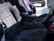 1993 Mazda MX-3 - Close-up of car's interior, focusing on the seats and an added armrest between them.