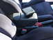 1993 Mazda MX-3 - Close-up of car interior with focus on the armrest and seats.