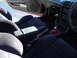 1993 Mazda MX-3 - Interior view of a car's front seats, center console, and dashboard details.
