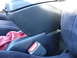 1993 Mazda MX-3 - Interior view of a car's center console and seatbelt buckle.