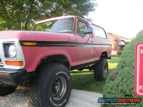 Red Ford Bronco with BFGoodrich tires parked outside