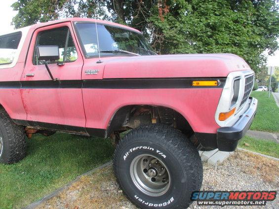 1979 Ford Bronco, red with black side stripe, lifted with off-road tires