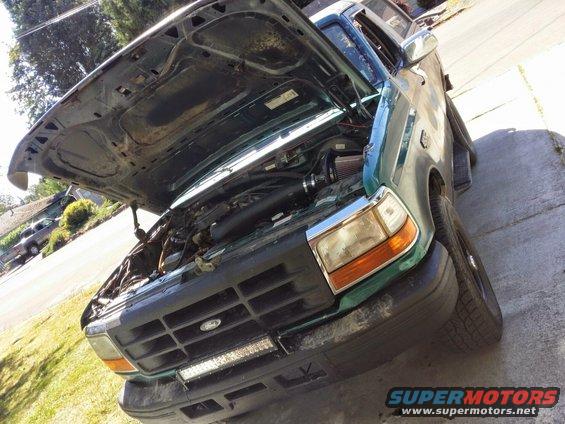 Green 1996 Ford Bronco front view with hood open, engine exposed