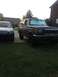 1990 Ford Bronco - A dark blue 1990 Ford Bronco is parked on a driveway with a silver SUV beside it.