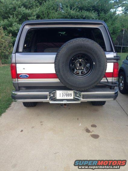 1990 Ford Bronco rear view, grey and red stripe, spare tire on back, Tennessee license plate A 37089
