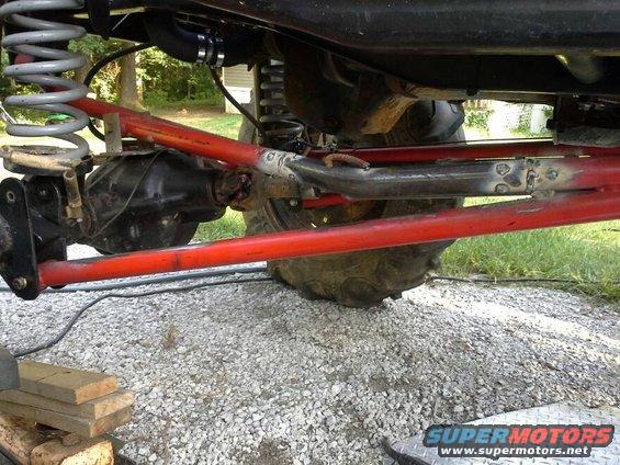 Close-up of red suspension arms and differential on a vehicle