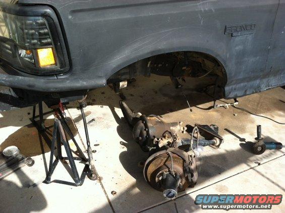 1995 Ford Bronco rear axle and suspension components removed and laid out on the ground