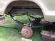 1979 Ford Bronco - Close-up view of the rear suspension system of a vehicle, showing leaf springs and the axle.