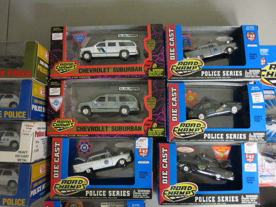 Collection of Road Champs die-cast police cars in packaging