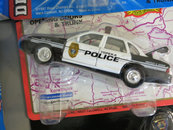 Topeka Police toy car in packaging with a map background