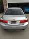 2014 Honda Accord - Rear view of a silver 2014 Honda Accord sedan parked in front of a garage.