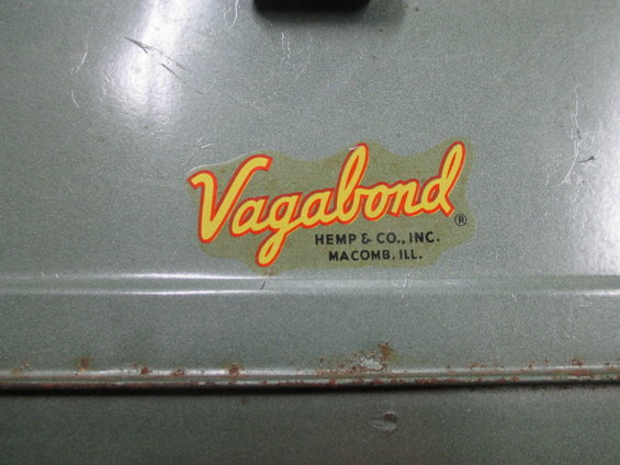 Close-up of a "Vagabond" sticker on a metal surface. Text below reads "HEMP & CO., INC. MACOMB, ILL."