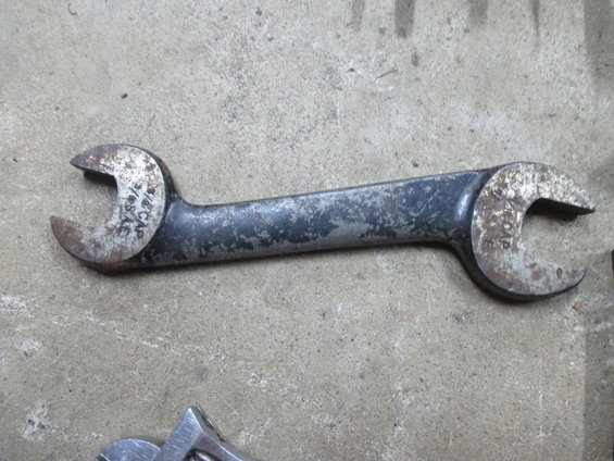 Combination wrench with 3/4 SAE and 13/16 CAP markings, showing wear and rust
