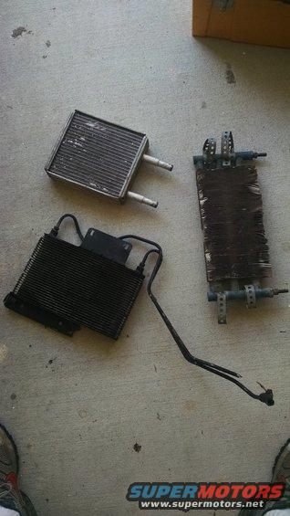 Three car radiators or heat exchangers on a concrete floor