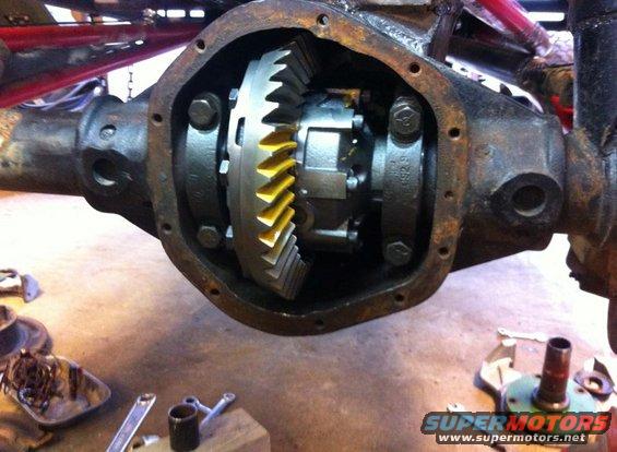 Differential gear assembly with yellow-tipped teeth, viewed from the rear