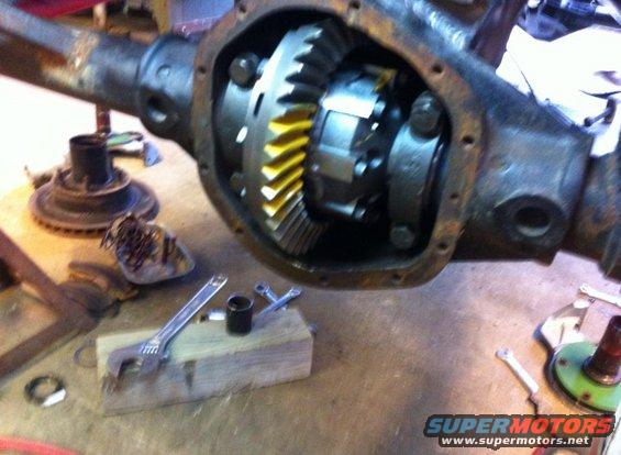 Differential gears with yellow teeth, part of a vehicle's drivetrain