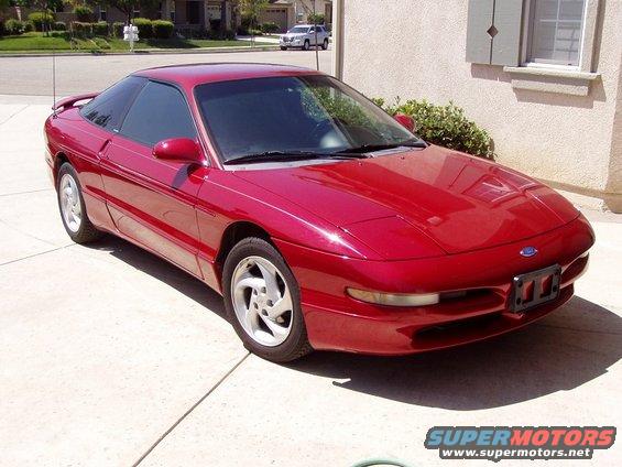Red 1995 Ford Probe parked on a driveway