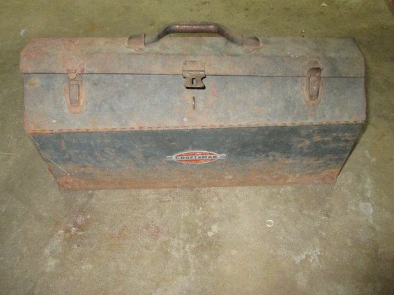 Rusty metal toolbox with a red and orange Craftsman logo
