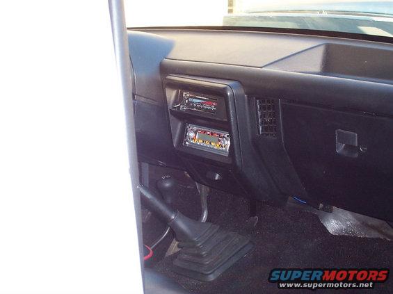1990 Ford Bronco interior showing dashboard, dual DIN radios, and floor shifter