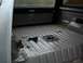 1990 Ford Bronco - The interior of a truck bed is shown, stripped down with various parts scattered on the floor.