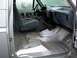 1990 Ford Bronco - The interior of a 1990 Ford Bronco shows gray seats and a bare metal floor with visible wear.