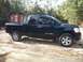 2006 Nissan Titan - Nissan Titan pickup truck with V8 TITAN badging on the side door.