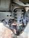 2006 Nissan Titan - This image shows the front suspension components of a vehicle, including the coil spring and strut assembly.
