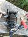 2006 Nissan Titan - Strut assembly being worked on with a spring compressor tool and an air impact wrench.