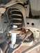 2006 Nissan Titan - Close-up of a vehicle's front suspension system, focusing on the strut and shock absorber assembly.