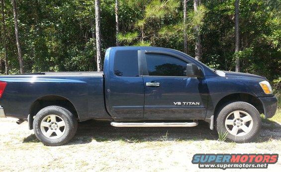 Side view of a dark blue 2006 Nissan Titan pickup truck with V8 Titan badging