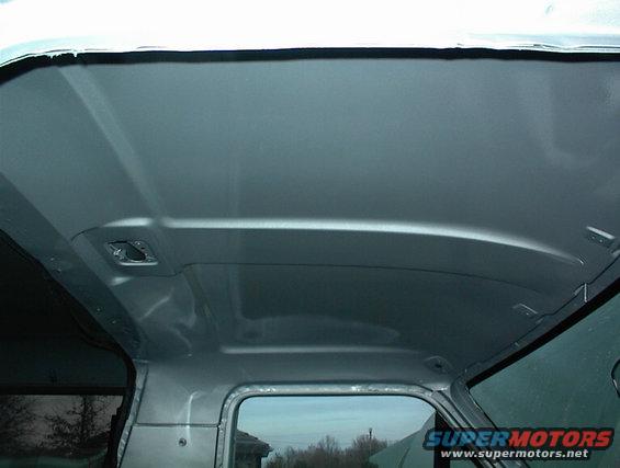 Interior roof of a vehicle, silver paint, showing structural details