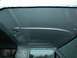 1990 Ford Bronco - The interior roof of a vehicle, painted silver, reveals its structural contours and mounting points.