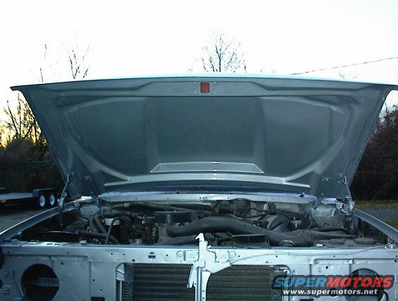 truck engine bay with hood open, showing engine components and radiator