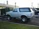 1990 Ford Bronco - This lifted Ford Bronco has a two-tone paint scheme and aftermarket wheels, but the rear bumper is missing.