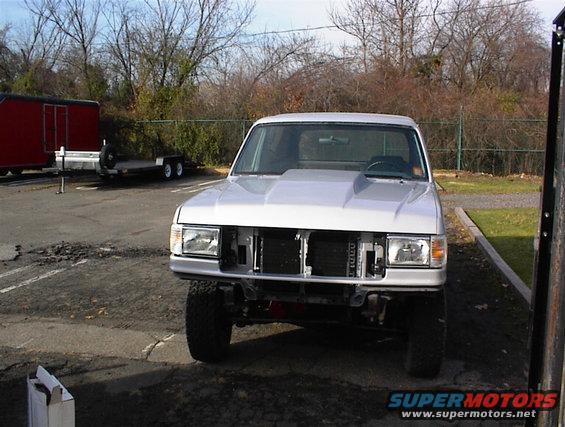 1990 Ford Bronco front view, hood removed, showing grille and headlights