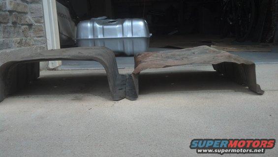 New gas tank and two old metal shields on concrete floor