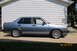 1990 Volkswagen Jetta - Side view of a blue 1990 Volkswagen Jetta sedan with tinted windows and a rear spoiler.