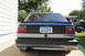 1990 Volkswagen Jetta - Rear view of a 1990 Volkswagen Jetta, showing its taillights and license plate. Another vehicle is parked nearby.