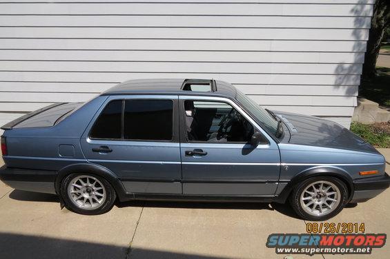 Side view of a blue 1990 Volkswagen Jetta with a sunroof