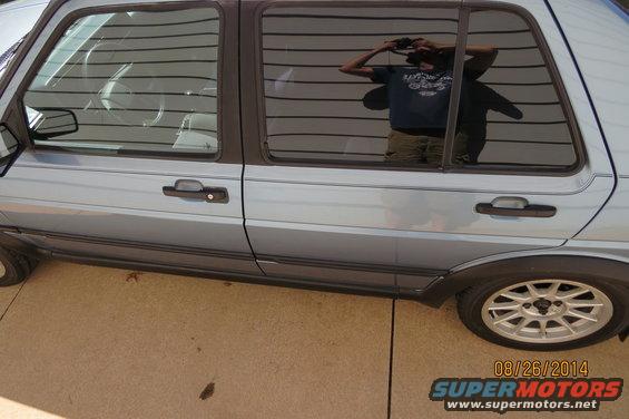 Light blue 1990 Volkswagen Jetta side view, showing tinted windows and alloy wheels