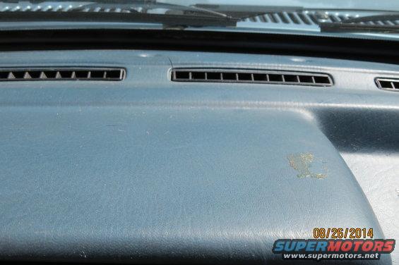 Dashboard interior with air vents and a date stamp