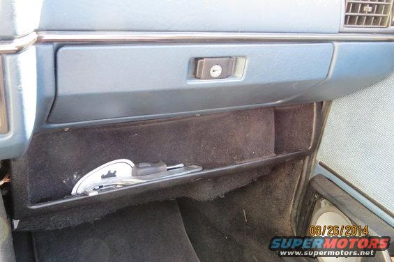 Car's open glove box with keys inside. Date stamp on photo reads 08/26/2014