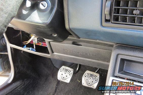 Volkswagen Jetta interior showing fuse box, pedals, and VAG Service System compartment