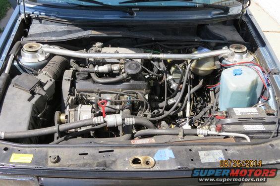 1990 Volkswagen Jetta engine bay with strut bar and battery