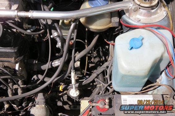 Engine bay with hoses, wires, and fluid reservoirs. Date stamp reads 08/26/2014