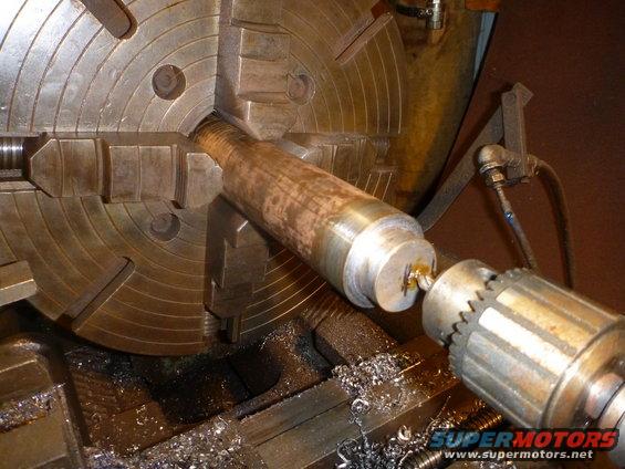 Metal shaft in a lathe chuck, being worked on