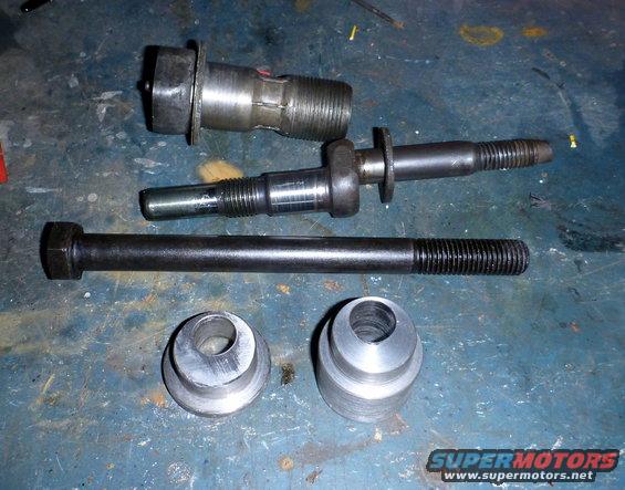 Various suspension bolts and bushings on a blue surface