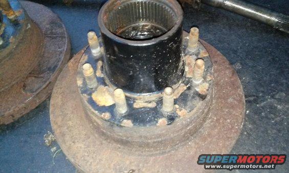 Rusty wheel hub assembly with six lug bolts and a splined center