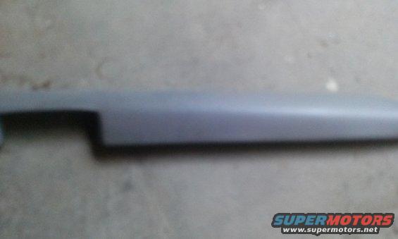 gray plastic trim piece with a cutout on the left side